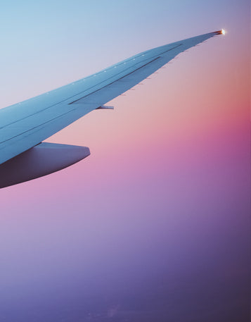 A picture of the end of an airplane wing on a multicolored background.