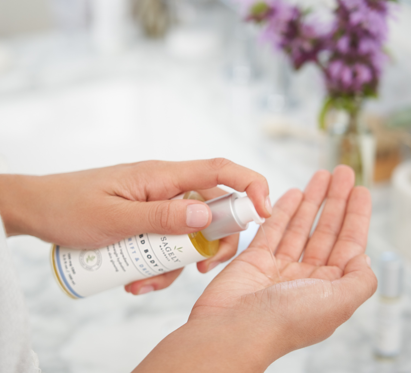Woman applying Sagely Naturals Drift & Dream CBD Body Oil