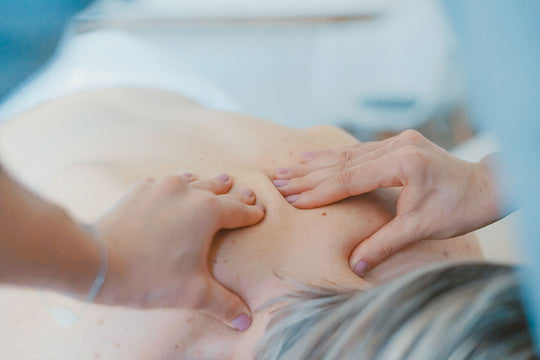 A person receiving a CBD massage on their back