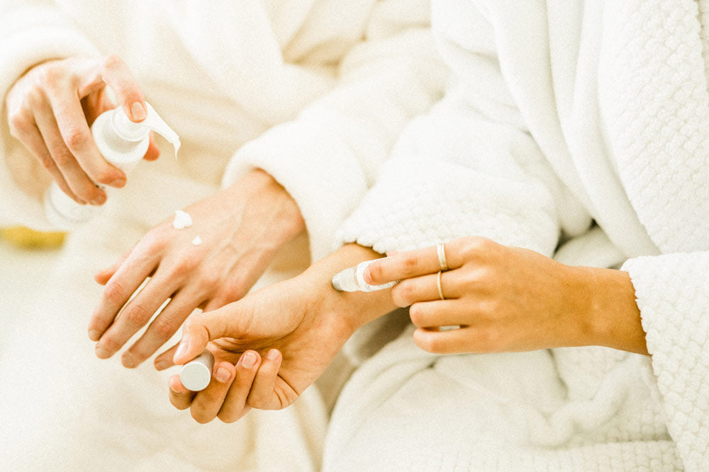Sagely Naturals CBD Roll On and CBD Cream being applied by two women white robes at a spa.