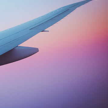 A picture of the end of an airplane wing on a multicolored background.