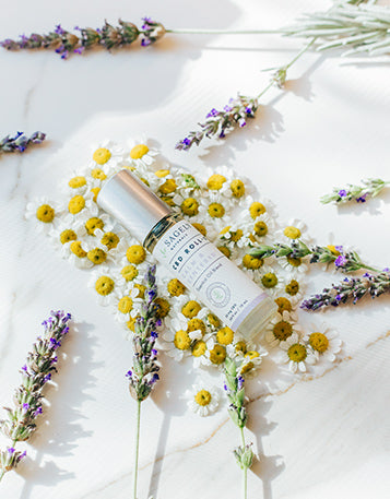 Sagely Naturals Calm & Centered CBD Roll-On lying among flowers.