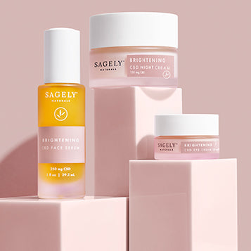 Sagely Naturals Brightening CBD Skincare Collection photographed on pink risers with a pink backdrop