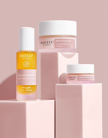 Sagely Naturals Brightening CBD Skincare Collection photographed on pink risers with a pink backdrop
