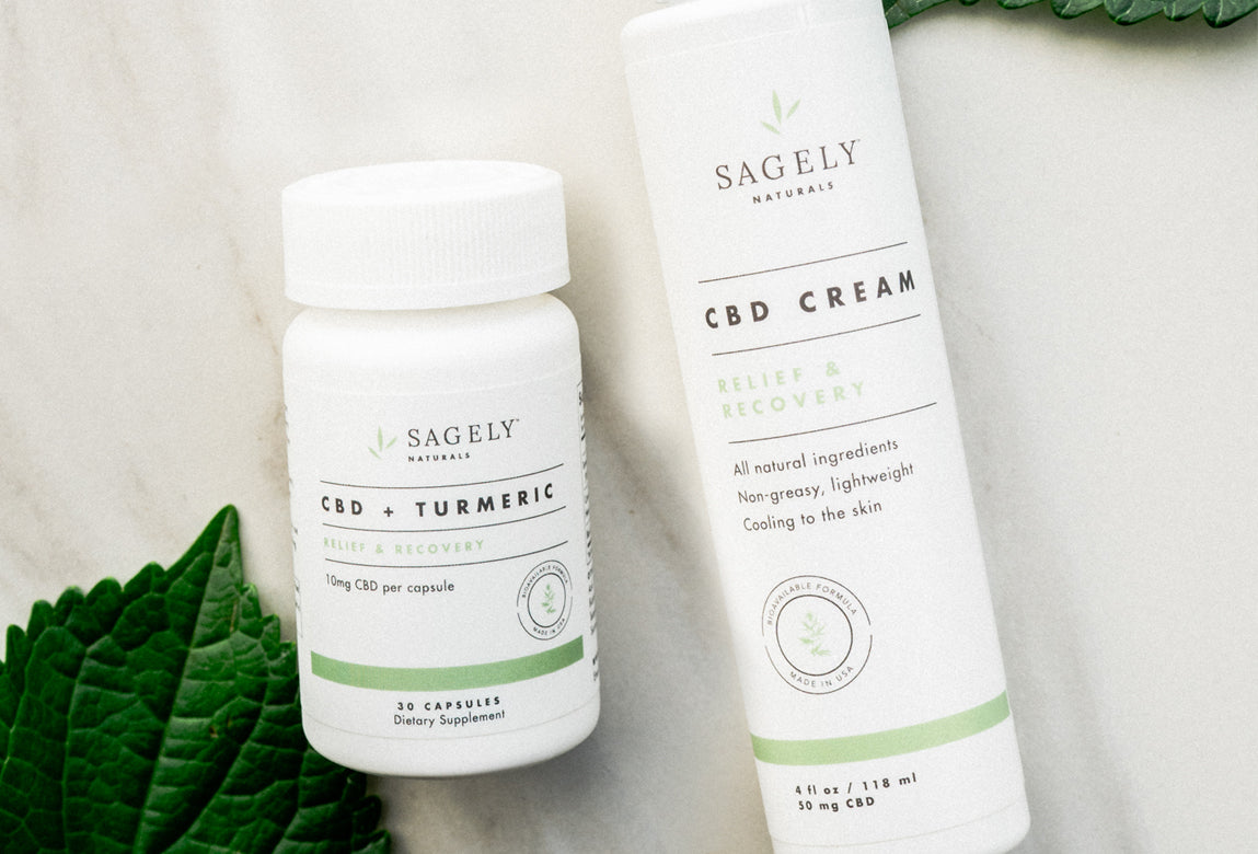 The Sagely Naturals Relief & Recovery cream + capsules photographed on white granite.